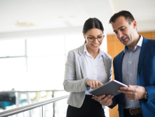 Two business people discussing business strategy using a tablet