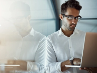 Young businessman working on his laptop in the office