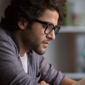 Knowledge and researching zoomed in image of man reading and using laptop
