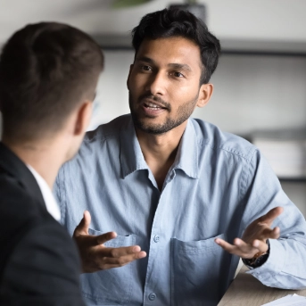 man talking with another man using hands