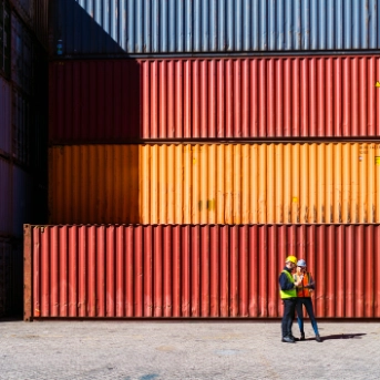 Two workers having a conversation about containers
