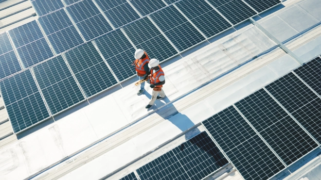 Two solar panel workers walking