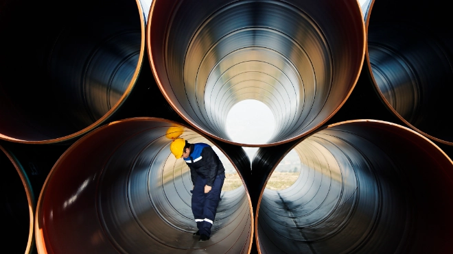 Worker inside industrial pipes