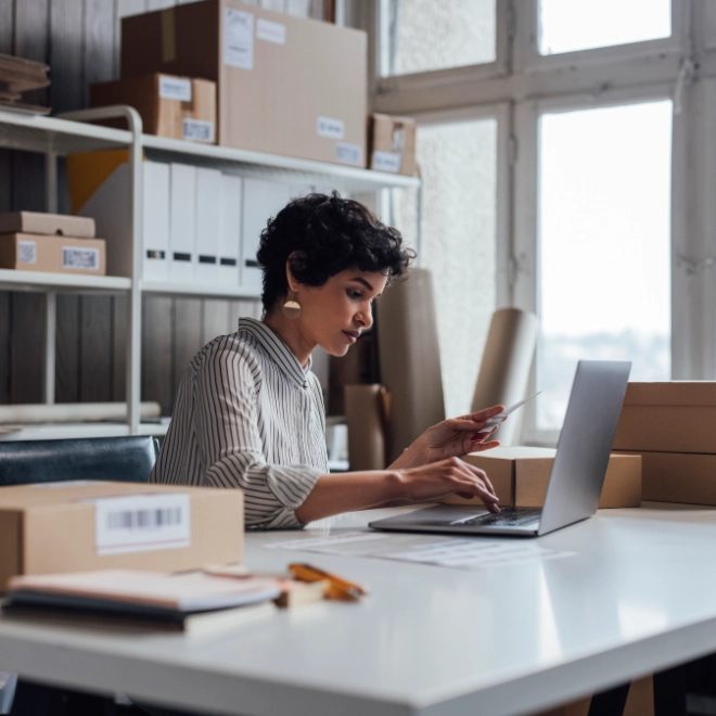 Woman in office surrounded by boxes