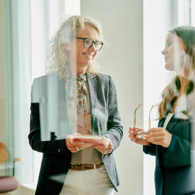 Atradius Danish colleagues talking in the office