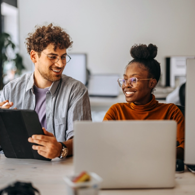 woman and man behind computers
