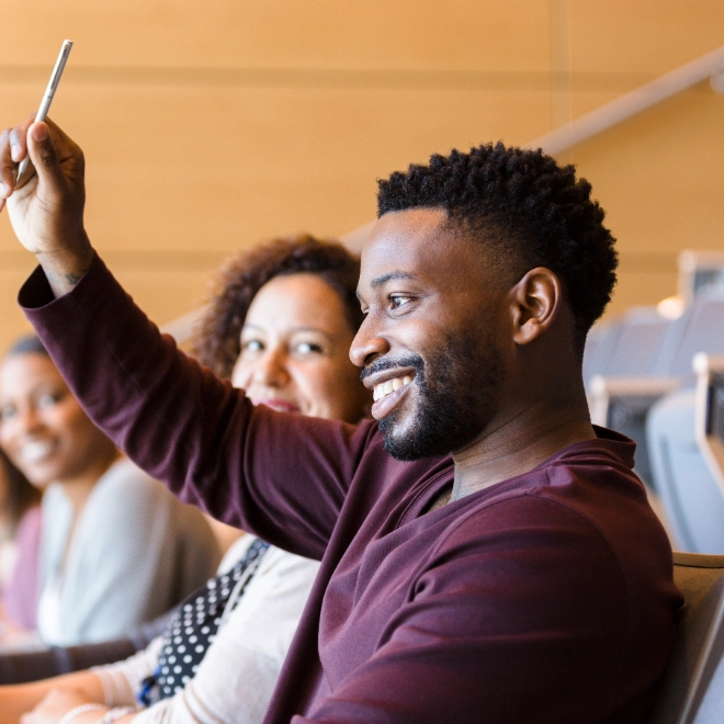Man raising his hand to ask a question